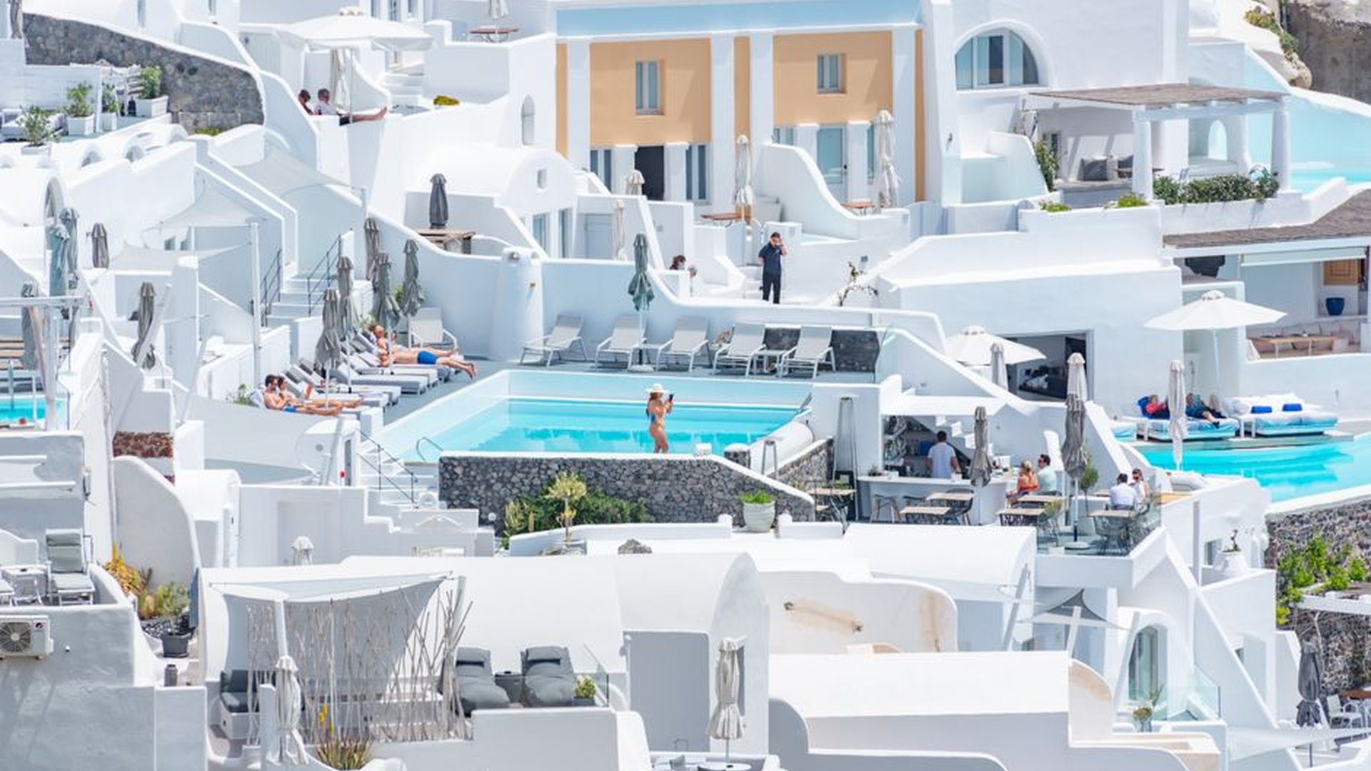Santorini sunset hotel pool mid-September tourists