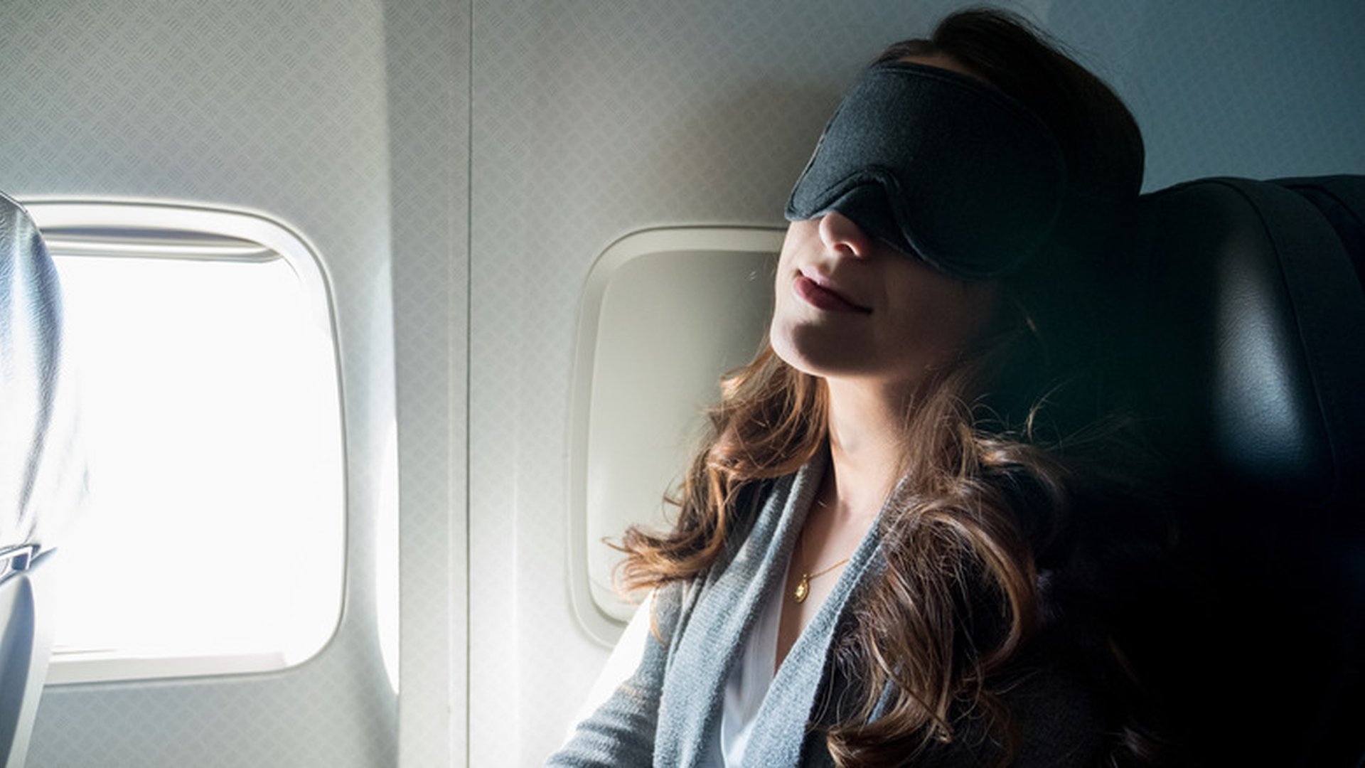 airplane cabin window seat sleeping passenger eye